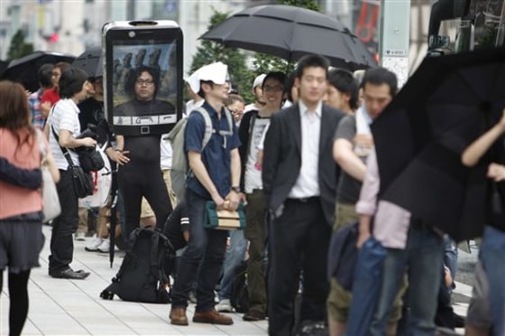 Customers line up to buy Apple's newest iPhone outside an Apple Inc's store at the Ginza district in Tokyo, Japan Thursday, June 24, 2010. Hundreds more lined up across the city at Apple stores and other Softbank outlets.